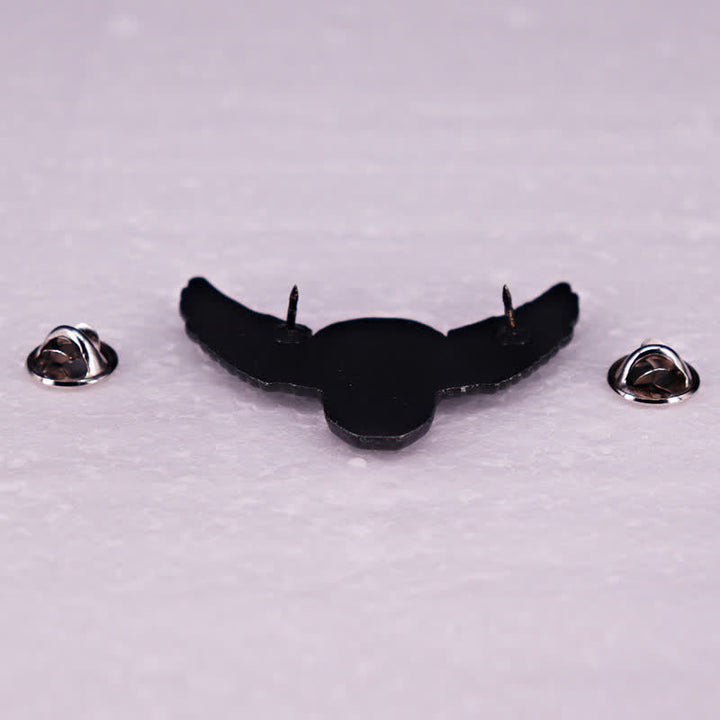 Broche tête de mort démoniaque ailée et riante
