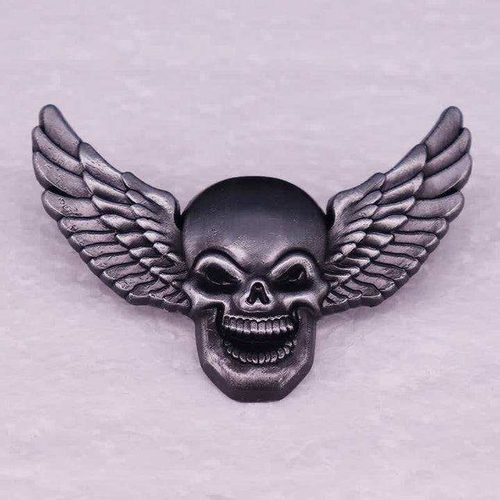 Broche tête de mort démoniaque ailée et riante