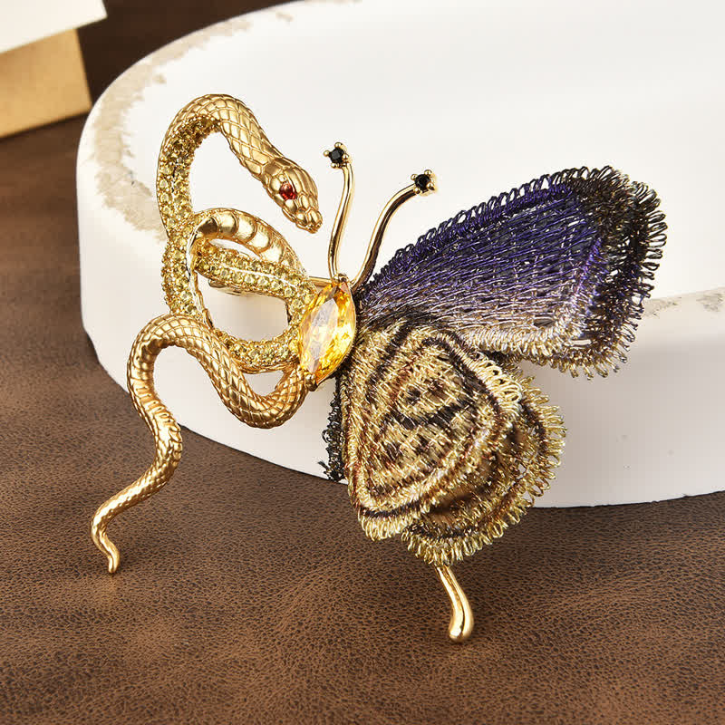 Broche pour femme avec broderie violette et serpent doré