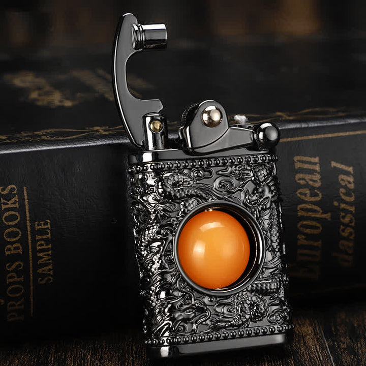 Briquet au butane rechargeable Dragon jouant avec une perle orange