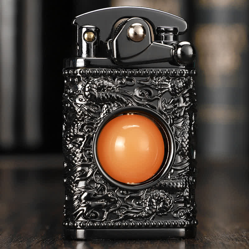 Briquet au butane rechargeable Dragon jouant avec une perle orange