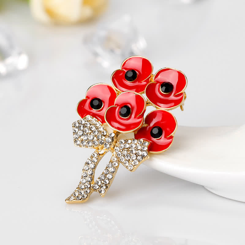 Broche fleur en strass avec noeud papillon et cinq coquelicots rouges