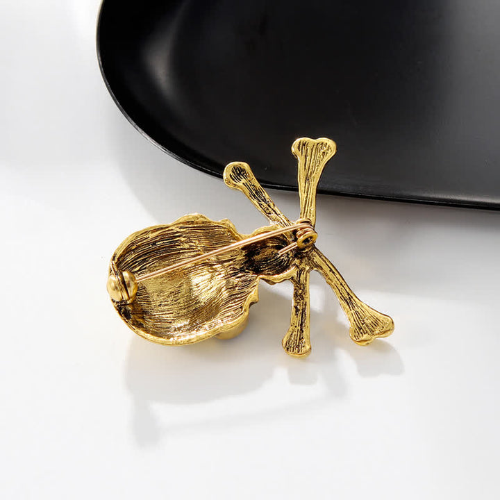 Broche décorative punk en forme de tête de mort et d'os croisés