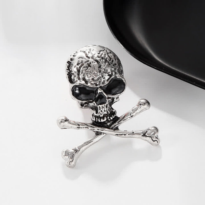 Broche décorative punk en forme de tête de mort et d'os croisés