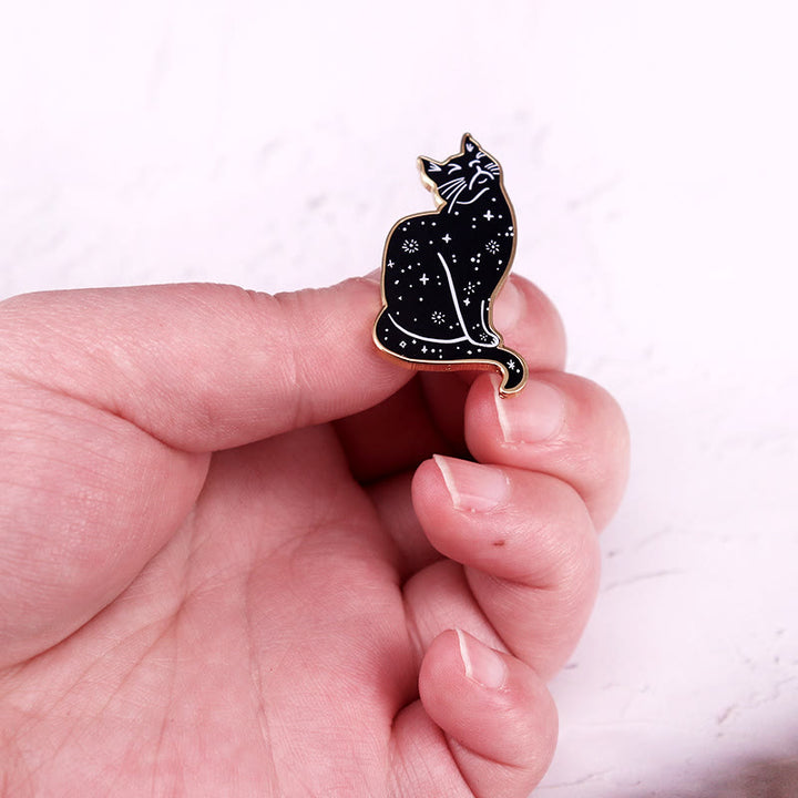 Broche en émail représentant un chat mystique au ciel étoilé