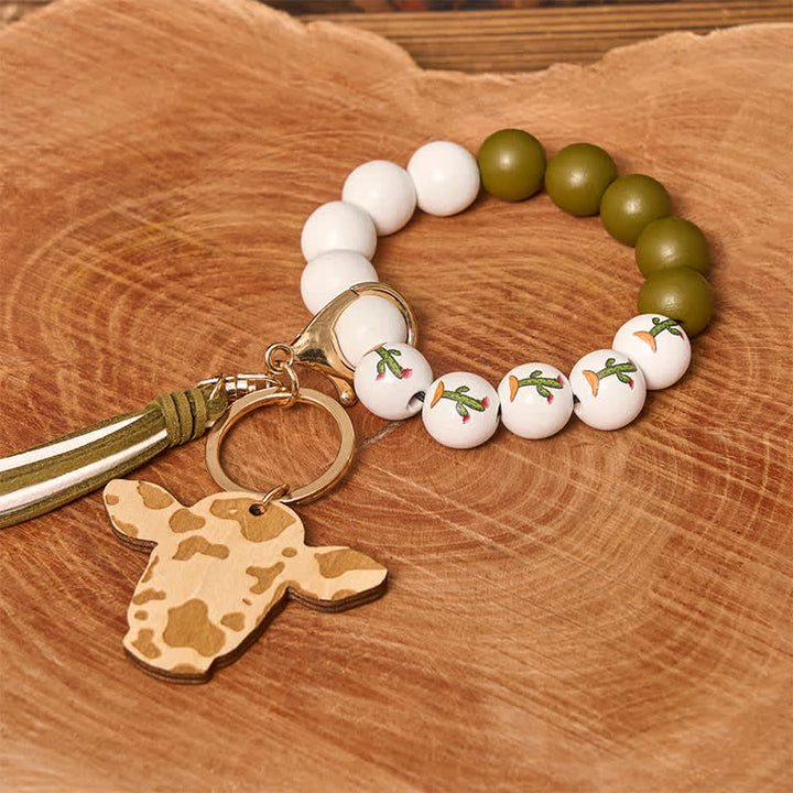Bracelet western en perles de bois de vache avec pompon
