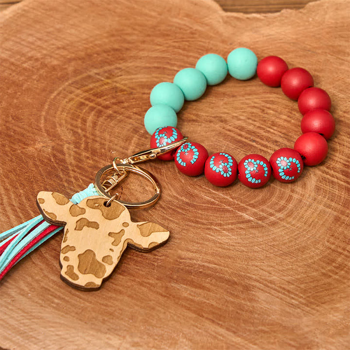 Bracelet western en perles de bois de vache avec pompon