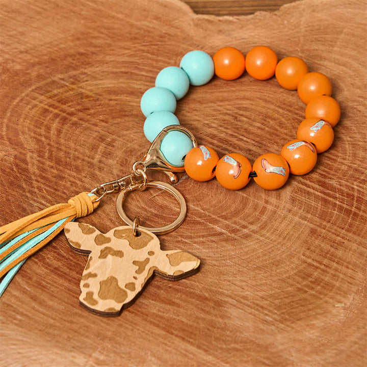 Bracelet western en perles de bois de vache avec pompon