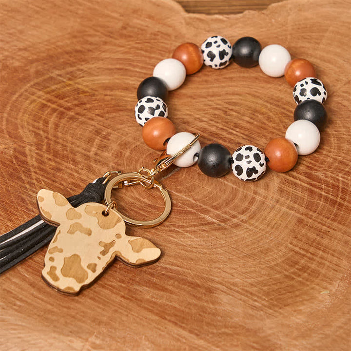 Bracelet western en perles de bois de vache avec pompon