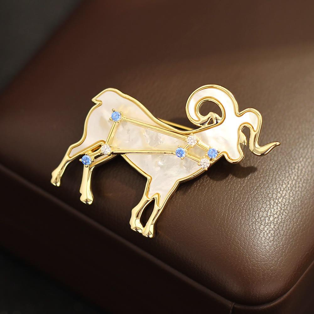 Broche en nacre et cristal bleu, or, représentant les 12 constellations - image 1